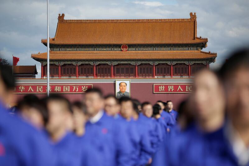 Workers attend a tribute ceremony in front of the Monument to the People's Heroes at Tiananmen Square, ahead of National Day marking the 69th anniversary of the founding of the People's Republic of China in Beijing, China. Reuters