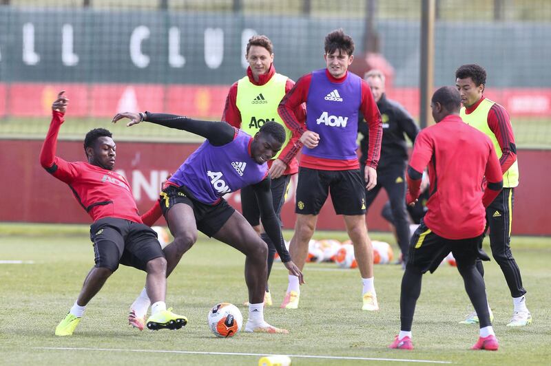 MANCHESTER, ENGLAND - JUNE 05: Timothy Fosu-Mensah and Paul Pogba of Manchester United in action during a first team training session at Aon Training Complex on June 05, 2020 in Manchester, England. (Photo by Matthew Peters/Manchester United via Getty Images)
