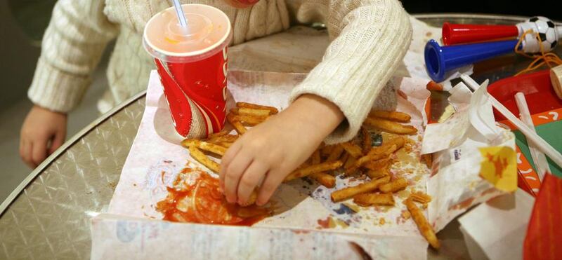 A girl enjoys food from Popeyes at Abu Dhabi Mall. Sammy Dallal / The National