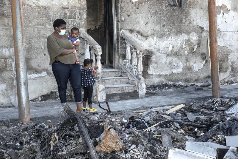 RAS AL KHAIMAH, UNITED ARAB EMIRATES. 28 OCTOBER 2020. A fire in Ras Al Khaimah has left business owner Taiwo Philip Akinmoladun with a devastating loss of stock in his second hand furniture business. with him sifting through the left overs is his wife Damilole Eniola along with their daughter Sofia and baby sun Henry. (Photo: Antonie Robertson/The National) Journalist: Ruba Haza. Section: National.
