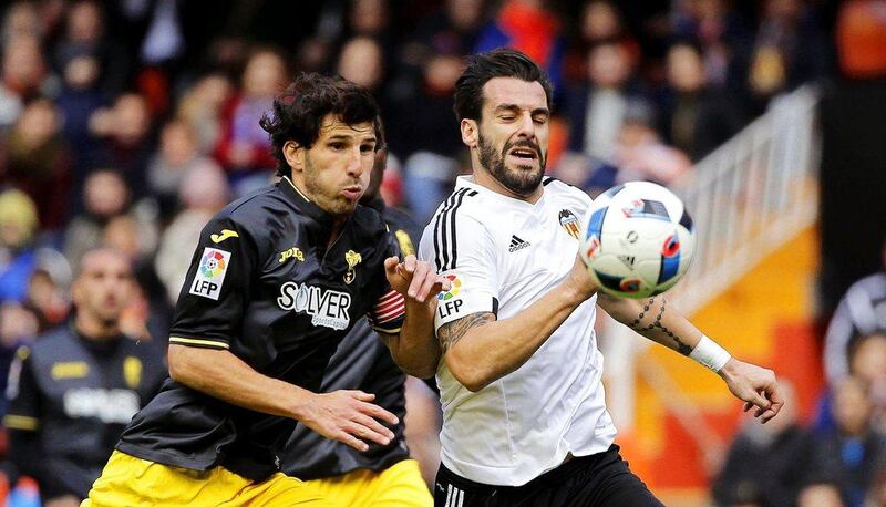 Valencia's striker Alvaro Negredo (R) in action against Granada's defender Diego Mainz (L) during the Spanish King's Cup round of 16 first leg soccer match between Valencia CF and Granada CF at the Mestalla stadium in Valencia, eastern Spain, 06 January 2016. Manuel Bruque / EPA