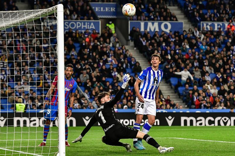 Barcelona's Pierre-Emerick Aubameyang, left, tries a shot against Real Sociedad. AP Photo