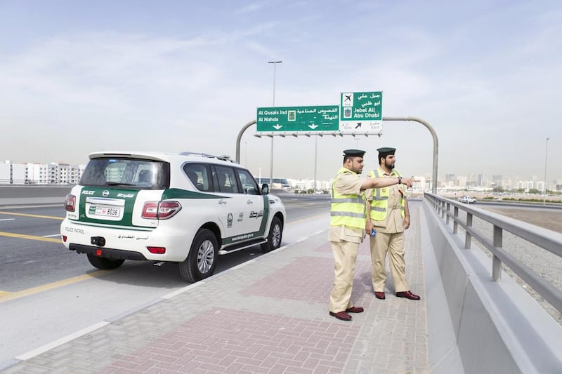 First Lieutenants, Essa Ahmed, left, and Mohammad Al Badwawi survey traffic on Sheikh Mohammed bin Zayed Road. Reem Mohammed / The National