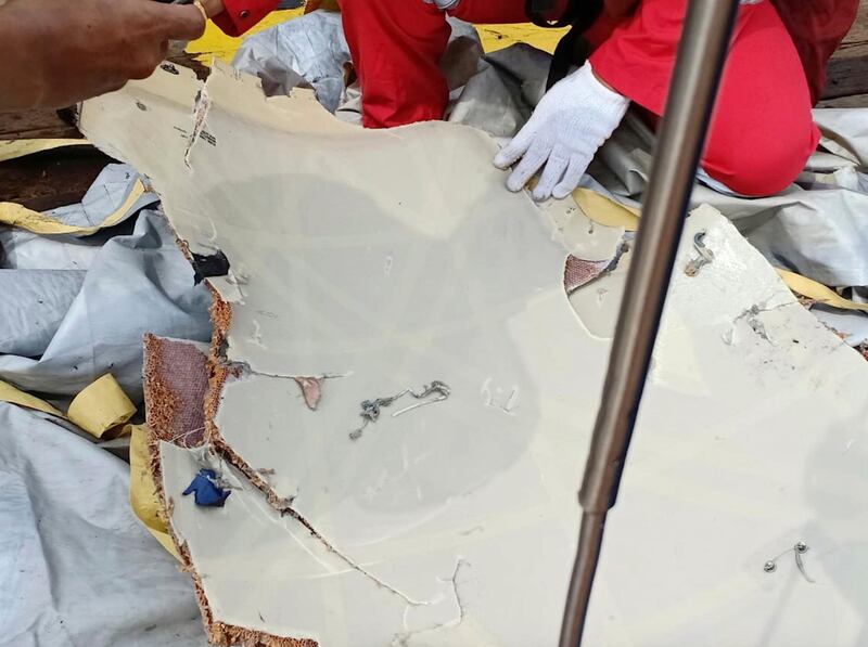 A rescuer inspects debris believed to be from Lion Air passenger jet that crashed off West Java. AP Photo