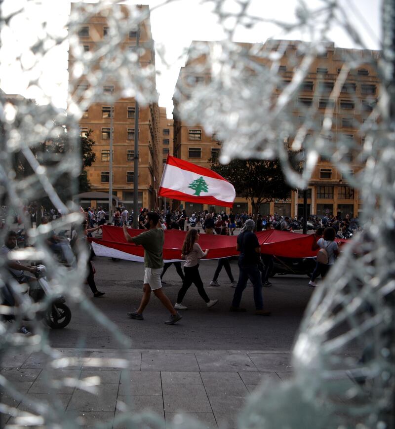 Demonstrators wave flags in downtown Beirut. AFP