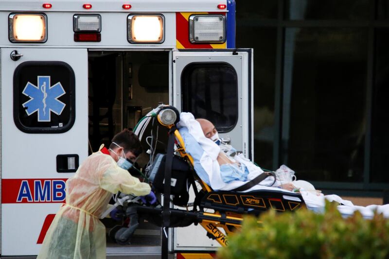 Rescue workers push a stretcher with a patient from the Zaandam of the Holland America Line cruise ship, afflicted with coronavirus disease (COVID-19), at Broward Heatlh Medical Center in Fort Lauderdale, Florida, U.S., April 2, 2020. REUTERS/Marco Bello