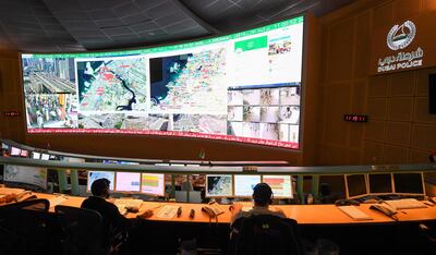 Police officers monitor the streets and receive calls from citizens at the Command and Control Center of Dubai Police in the Gulf emirate, on February 24, 2020. The novel coronavirus has given the Gulf emirate of Dubai an opportunity to showcase its technological and scientific clout as it seeks to shape its own model for approaching the pandemic. / AFP / KARIM SAHIB
