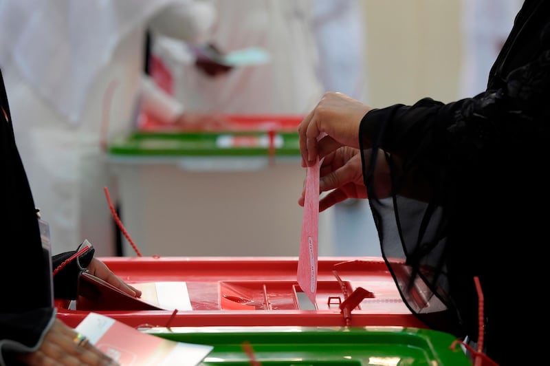 A Bahraini voter casts her ballot at a polling station in the Bahraini city of Al-Muharraq, north of Manama on November 24, 2018, as they wait to cast their vote in the parliamentary election. The polls opened at 8am local time (0500 GMT) and are set to close at 8pm. More than 350,000 Bahrainis are eligible to vote in Saturday's poll, according to justice minister Sheikh Khalid bin Ali al-Khalifa, adding that there were 54 polling stations across the country. 
 / AFP / STR
