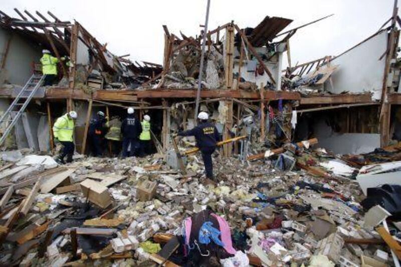 Firefighters sift through the debris of an apartment destroyed by an explosion at a fertiliser plant in West, Texas.