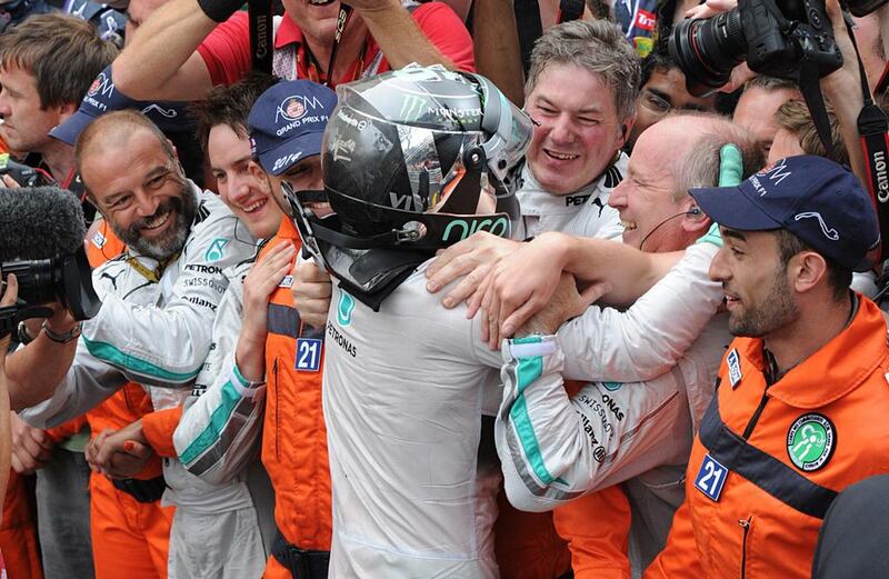 Mercedes-GP driver Nico Rosberg celebrates with Mercedes team members after the victory at the Monaco Grand Prix. Boris Horvat / AFP