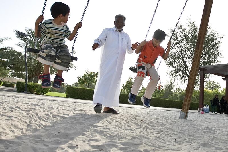 United Arab Emirates -Dubai- May 15, 2009:

HOUSE & HOME: Zubair Ali (cq-al), 53, center, pushes his nephews Houshad Haarith (cq-al), 3, left, and Al Haarith (cq-al), 6, right, on the swings of a playground in the Nad Al Sheba neighborhood in Dubai on Friday, May 15, 2009. Amy Leang/The National
 *** Local Caption ***  amy_051509_nadalsheba_22.jpgamy_051509_nadalsheba_22.jpg