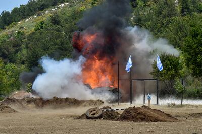 A missile fired from a drone explodes next to a fence with Israeli flags as part of a training exercise for Hezbollah. EPA