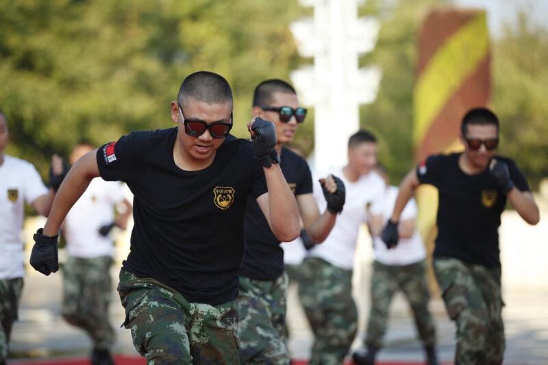 Chinese paramilitary soldiers dancing to Xiao Ping Guo - a song apparently so catchy that it has won over the army and police. China Out / AFP 

