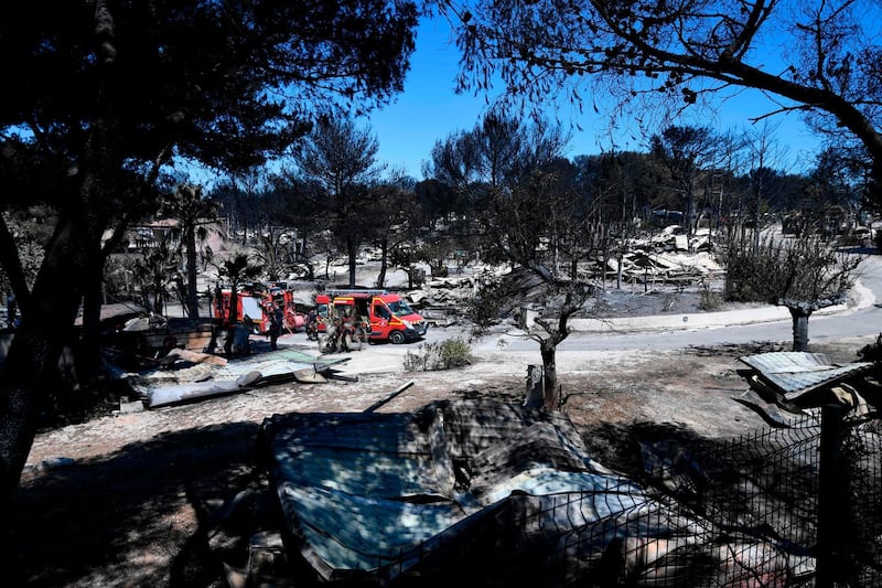 French firefighters check a camp site in La Couronne. AFP