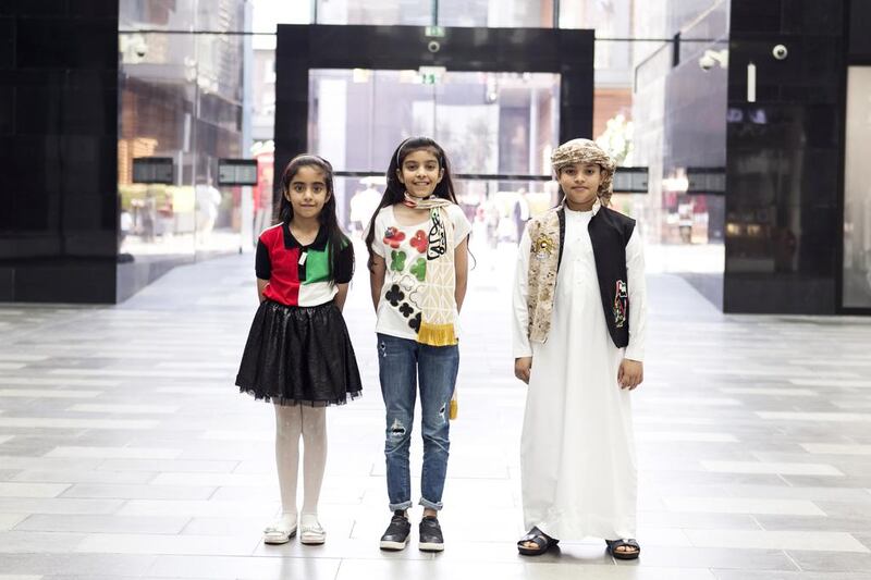 Khawla, 8, Mariam, 11, and Abdul Rahman, 10, at City Walk Dubai during UAE National Day. Reem Mohammed / The National