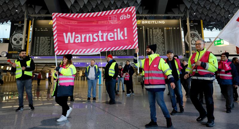 Members of the German public sector workers' union dbb picketing a terminal hall at Frankfurt's airport during a nationwide transport strike. EPA