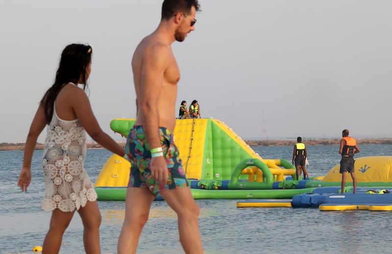 Beachgoers play at a floating blow-up water park at Pure Beach in King Abdullah Economic City.