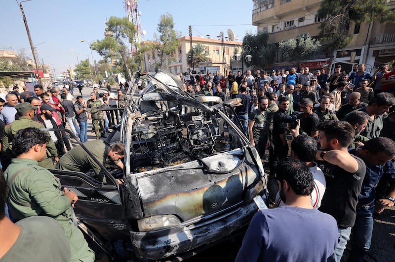 Members of the Syrian regime inspect the location where a car bomb exploded in the northeastern Syrian town of Qamishli which is mainly controlled by Kurdish forces, Syria. REUTERS