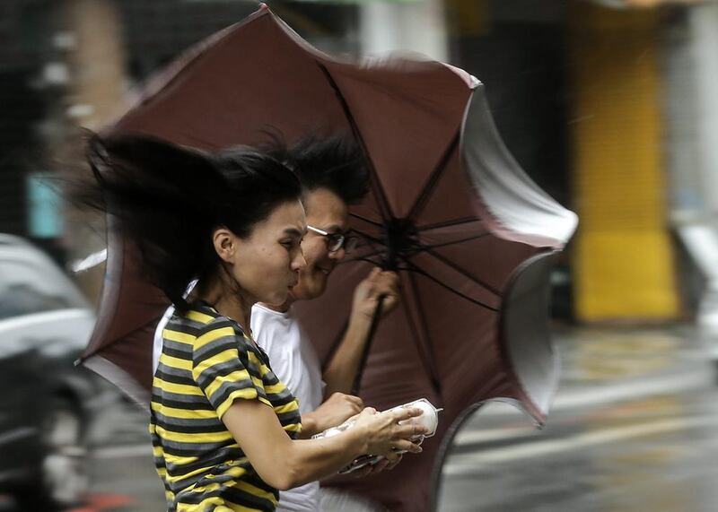 People brave heavy rains and strong wind as typhoon Megi hits Hualien county, eastern Taiwan. EPA