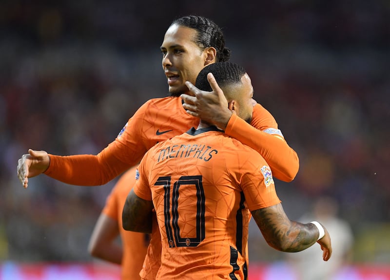 Netherlands' Memphis Depay celebrates with Virgil van Dijk after scoring against Belgium. AFP