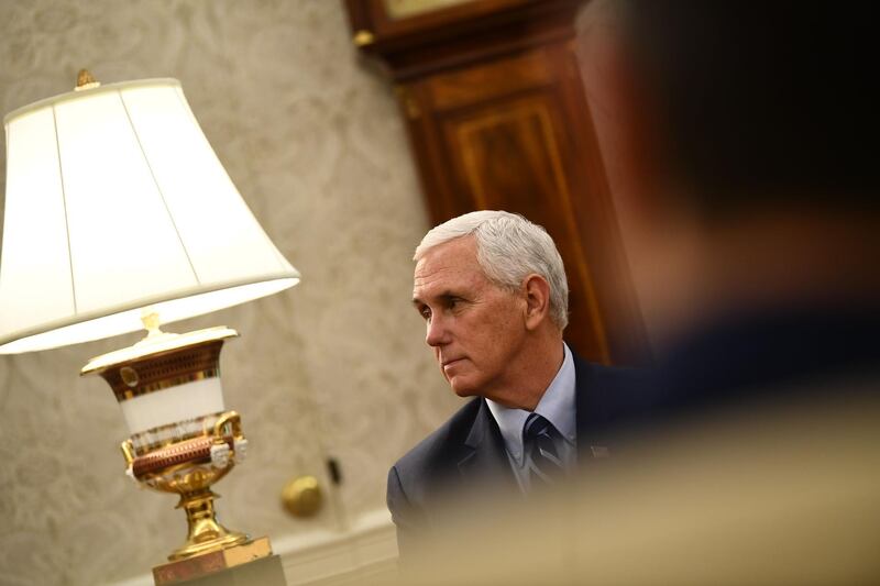 (FILES) In this file photo US Vice President Mike Pence listens as US President Donald Trump speaks during a meeting with Texas Governor Greg Abbott on May 7, 2020, in the Oval office of the White House in Washington, DC. US Vice President Mike Pence is not in quarantine and has tested negative to COVID-19, his spokesman said on May 10, after a close aide was confirmed to have been infected. Pence would go to work at the White House on Monday, spokesman Devin O'Malley said in a statement following some US media reports that Pence would be self-isolating.
 / AFP / Brendan Smialowski
