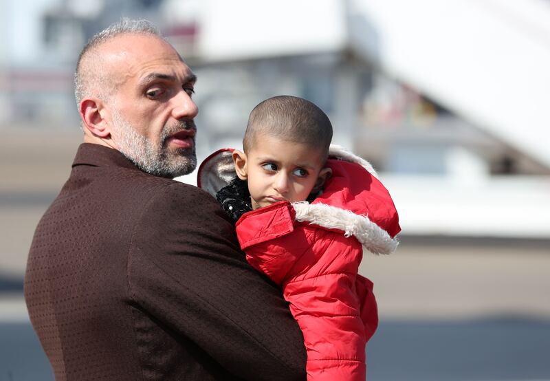 Cancer patients and injured people from Gaza arrive at Abu Dhabi International Airport. Chris Whiteoak / The National