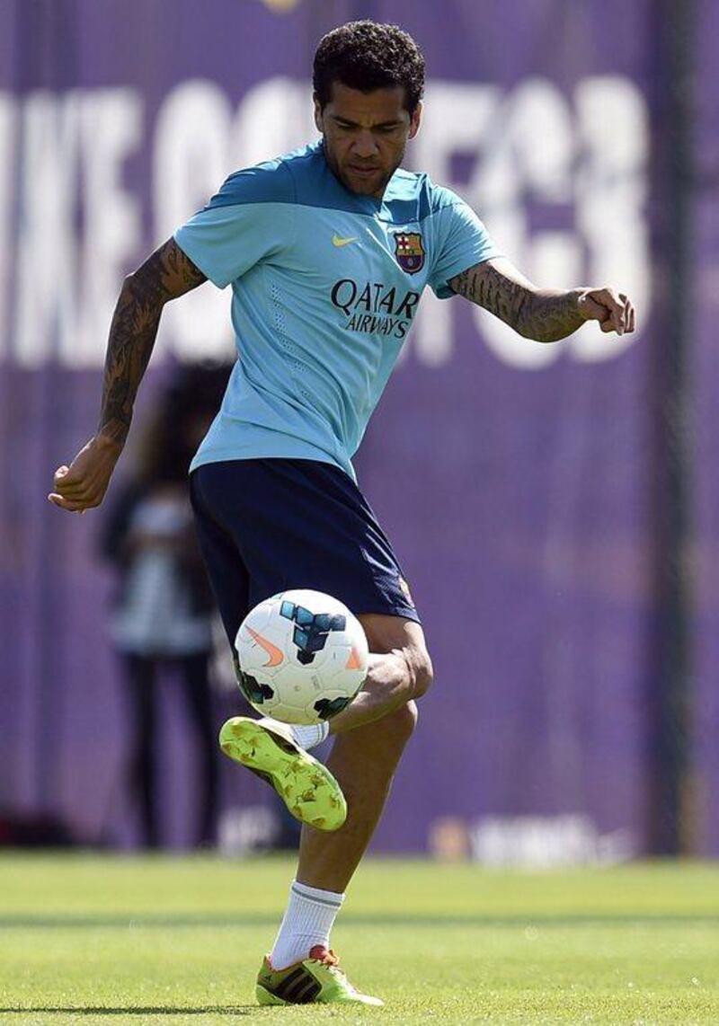 Barcelona defender Dani Alves juggles the ball during his team's training session for their Saturday bout with Atletico Madrid. Lluis Gene / AFP / May 16, 2014