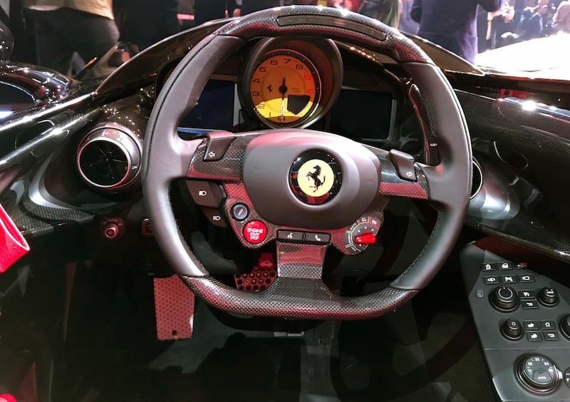A view of the cockpit of the Ferrari Monza SP2 on display in Maranello, Italy, Tuesday, Sept. 18, 2018. Sportscar maker Ferrari has unveiled two updated versions of its classic open-top "barchetta" racing model as it briefs investors on a new five-year business plan. Nicolo Boari, the head of product marketing, said Tuesday that the Ferrari Monza SP1 and SP2 are "the most powerful ever in Ferrari history," with an 810 horsepower engine able to reach 100 kilometers per hour (62 mph) in 2.9 seconds. (AP Photo/Collen Barry)