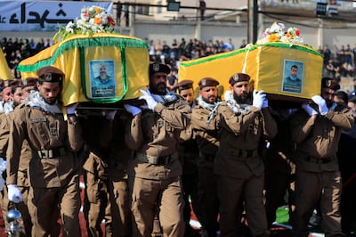 Hezbollah fighters carry the coffins of Hezbollah commander Ismail Baz, left, and another fighter who were killed by an Israeli drone strike, during a funeral procession in Chehabiyeh, south Lebanon. AP