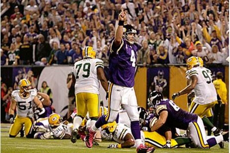 Brett Favre celebrates after throwing one of three touchdown passes against the Packers.