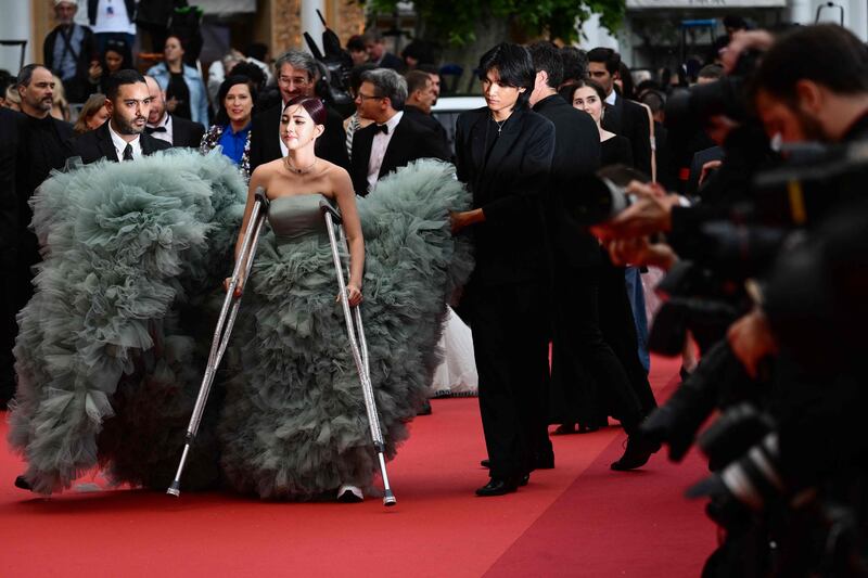 Not even crutches can stop Shin Yubin making an entrance. AFP