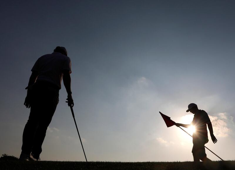 Rory McIlroy, left, alongside his caddy during the final round of the HSBC World Golf Championships in Shanghai on Sunday, November 3. The Northern Irishman won the tournament after beating  Xander Schauffele in a play-off. EPA