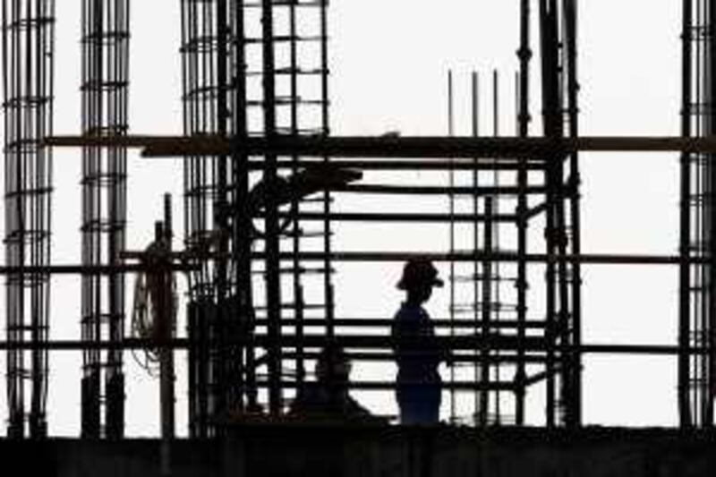 
DUBAI, UNITED ARAB EMIRATES Ð May 26: Labourer working on one of the under construction building at International City in Dubai.  (Pawan Singh / The National) 

 *** Local Caption ***  PS13-CONSTRUCTION.jpg