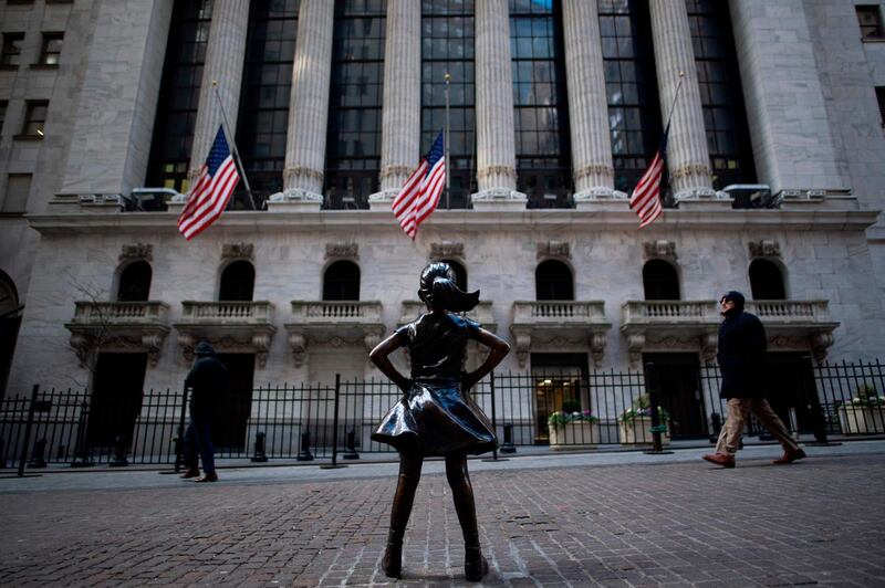 (FILES) In this file photo taken on January 09, 2019 the "Fearless Girl" statue stands facing the New York Stock Exchange (NYSE) in New York.   As a professional woman in her late 30s, Kate Packard was keen to start investing. Like many novices, her enthusiasm took a knock when she hit a wall of impenetrable jargon -- and was all but killed off by "mansplaining" from the men around her. Women are significantly less likely to invest in the market than men: based on studies from 2016 and 2017, the micro-investing app Acorns found 57 percent of women don't invest at all, versus 44 percent of men. / AFP / Johannes EISELE
