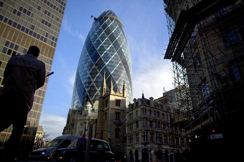 A pedestrian and vehicles pass 30 St Mary Axe, also known as The Gherkin, in London. Simon Dawson / Bloomberg