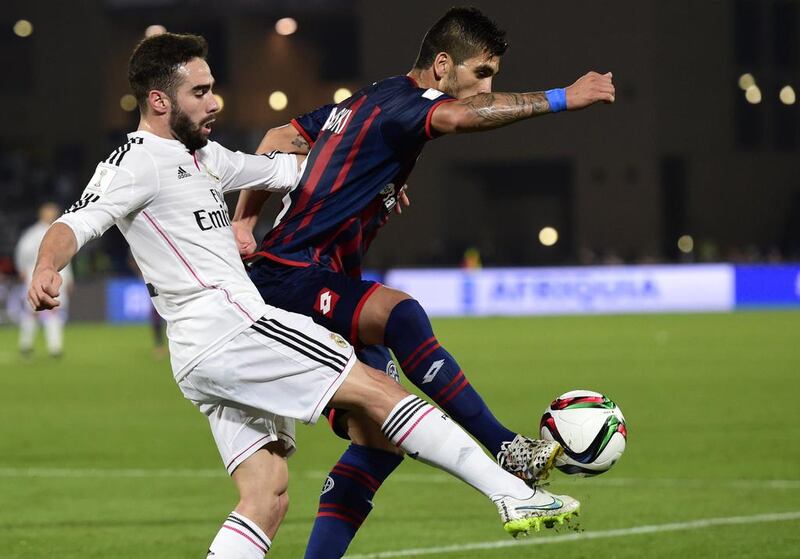 San Lorenzo’s midfielder Enzo Kalinski (R) vies for the ball with Real Madrid’s defender Dani Carvajal during their FIFA Club World Cup final football match at the Marrakesh stadium in the Moroccan city of Marrakesh on December 20, 2014. AFP PHOTO / JAVIER SORIANO