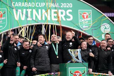 Manchester City staff celebrate with the trophy after the football team's win in the Carabao Cup Final at Wembley Stadium, London on March 1, 2020. John Walton / PA