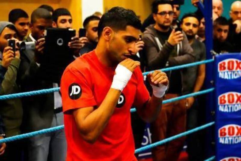 Amir Khan's proposed fight against IBF Welterweight champion Devon Alexander in Dubai appears to have stalled with the American yet to sign up to fight the Briton. Paul Eliis / AFP