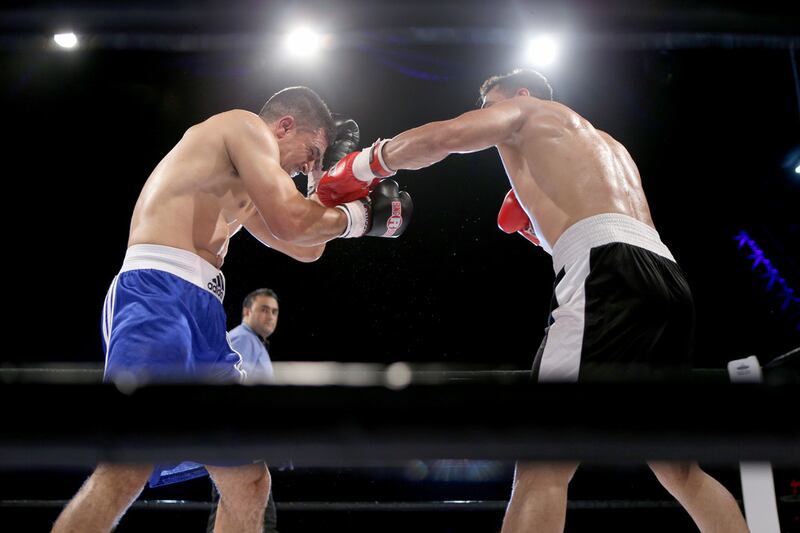 Mohammed Reza v Hakim Wahid. Reza, an Iranian, pictured in black, won by TKO in the second round against the Moroccan Wahid. Sammy Dallal / The National