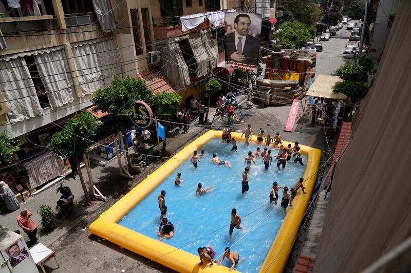 Children swim in an inflatable pool that supporters of former prime minister Saad Hariri installed to illustrate their intention to boycott parliamentary elections in Beirut, Lebanon. AP Photo