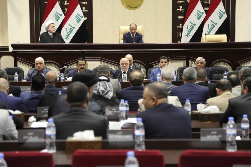 Iraqi Prime Minister Haider al-Abadi, center, attends a session of the Iraqi Parliament, in Baghdad, Iraq, Wednesday, Sept. 27, 2017. al-Abadi on Wednesday ordered the Kurdish region to hand over control of its airports to federal authorities or face a flight ban. (AP Photo/Karim Kadim)