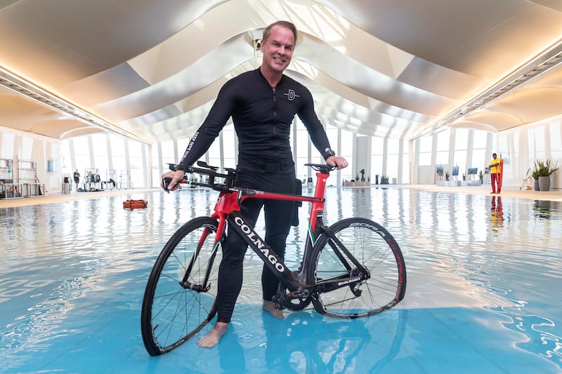 Mr Lundgren prepares to place a bicycle in the pool. 
