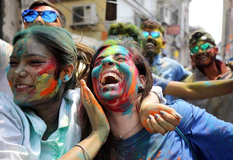 Tourists and locals apply colour dust to each other as they celebrate Holi festival in Kolkata, Eastern India. EPA