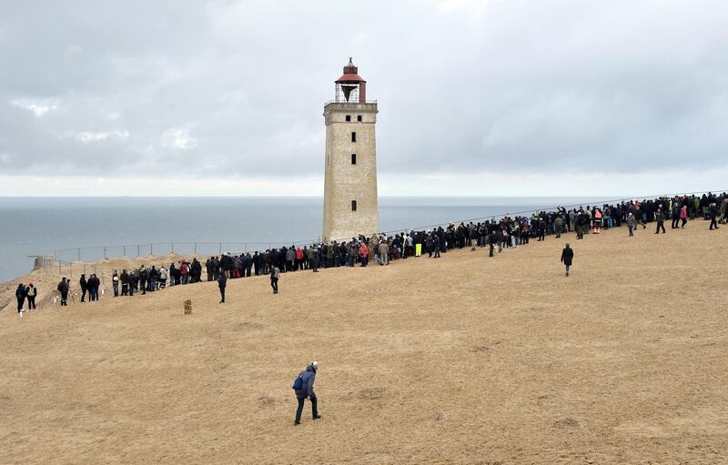 Workers prepare the Rubjerg Knude Lighthouse to be moved on rails in Jutland, Denmark. EPA