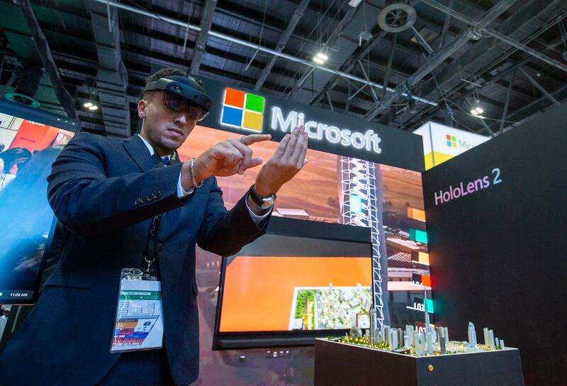A guest uses the new Microsoft HoloLens 2 at the company's stand at Gitex Technology Week in Dubai on Tuesday. Leslie Pableo / The National