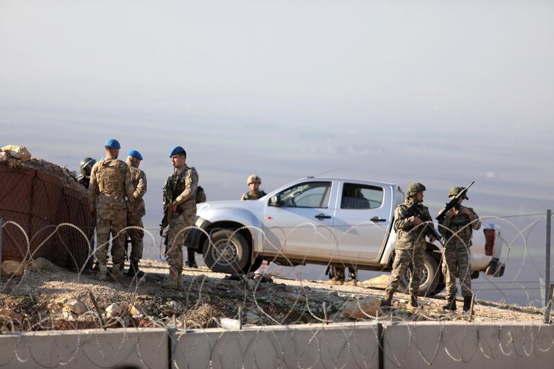 Turkish soldiers gather near the border with Syria during a symbolic demonstration in the city of Harem in the rebel-held northern countryside of Syria's Idlib on the border with Turkey.  EPA