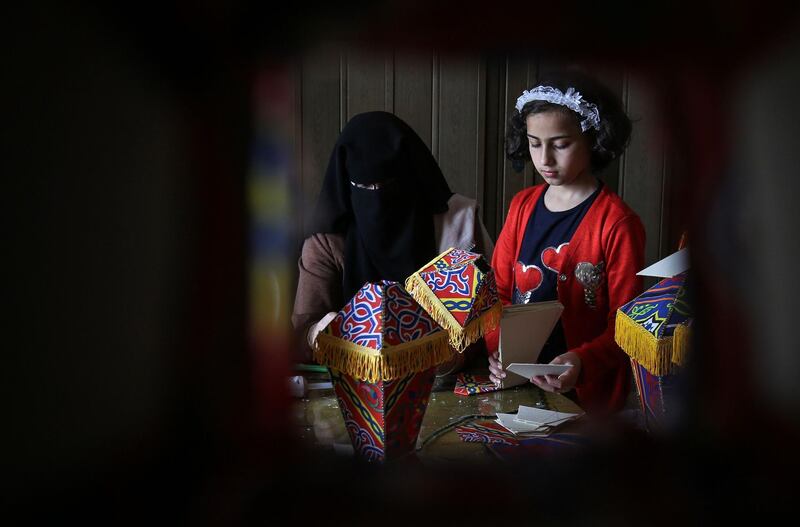 Members of a Palestinian family gather around a table during the novel coronavirus lockdown to make lanterns to sell ahead of the Muslim holy month of Ramadan, in Khan Yunis, in the southern Gaza Strip on April 15, 2020. AFP