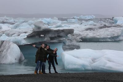 JOKULSARLON, ICELAND - JUNE 03:  Visitors enjoy the view of Icebergs that calved from glaciers on June 3, 2017 in Jokulsarlon, Iceland. Iceland's tourism industry continues to thrive; just eight years ago Iceland welcomed approximately 464,000 tourists and by last year nearly 1.7 million people visited the nation.  (Photo by Joe Raedle/Getty Images)