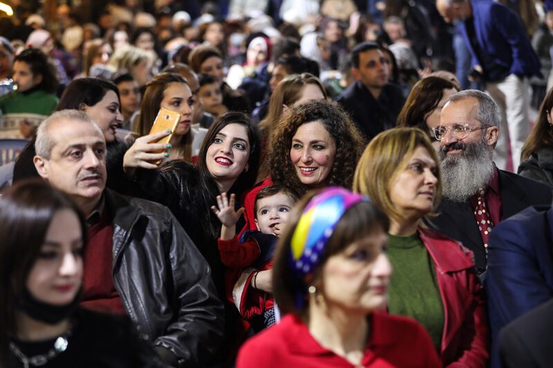 Residents of all ages attend the Christmas tree lighting ceremony in Gaza city.