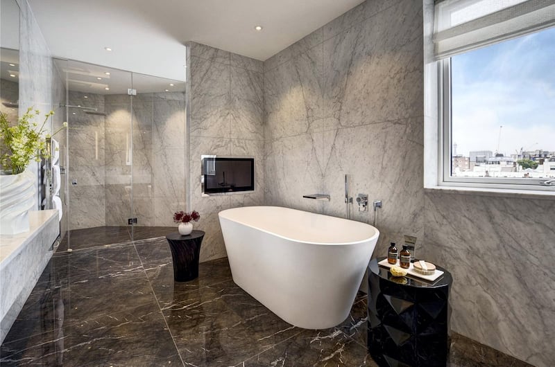 There is a generous master suite, featuring its own walk-in dressing room and large Carrara marble en suite bathroom with bath and shower facilities.. Courtesy Berkshire Hathaway HomeServices London